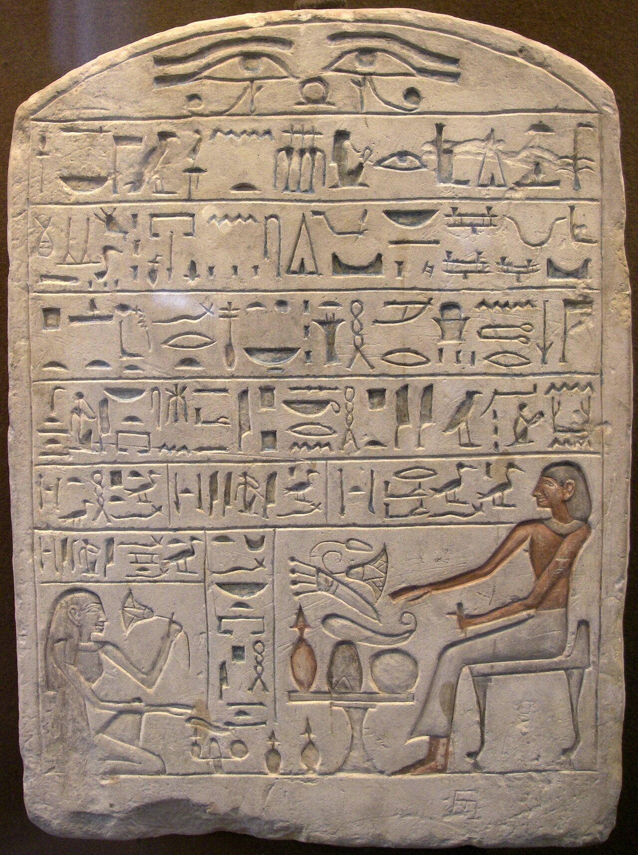 An ancient Egyptian stone carved with neat rows of hieroglyph writing.