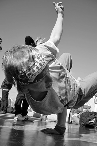 A breakdancer doing a cool move on the floor at a big event.