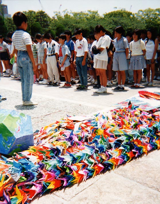 Colorful strings of folded paper cranes made as a wish for peace.