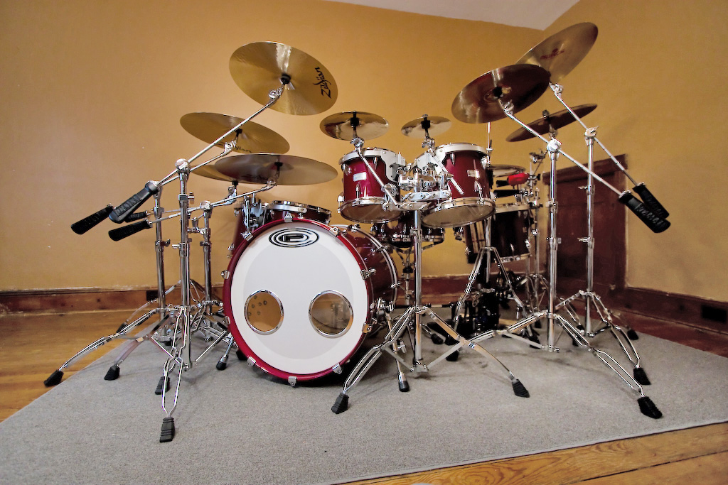 A full drum set with many shiny cymbals ready to play.