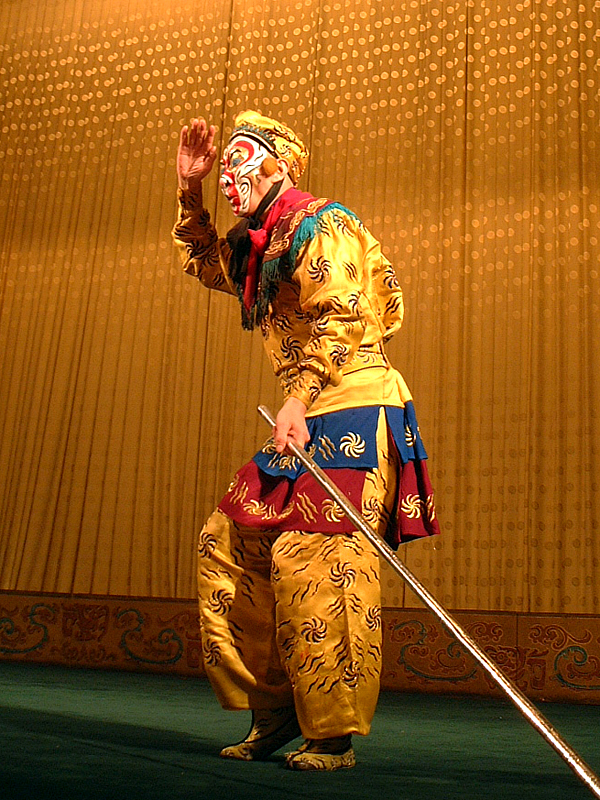 An actor in a colorful Monkey King costume on stage in Beijing.