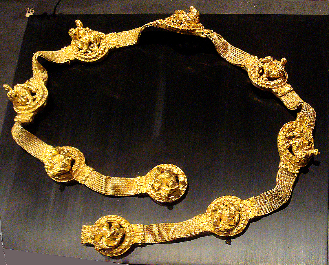 Fancy gold belt showing a man riding a lion.