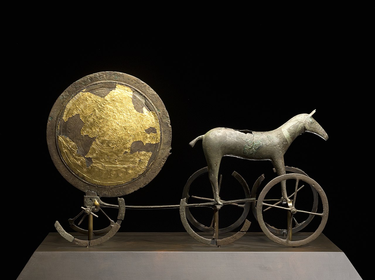 Small golden sun pulled by a bronze horse and cart.