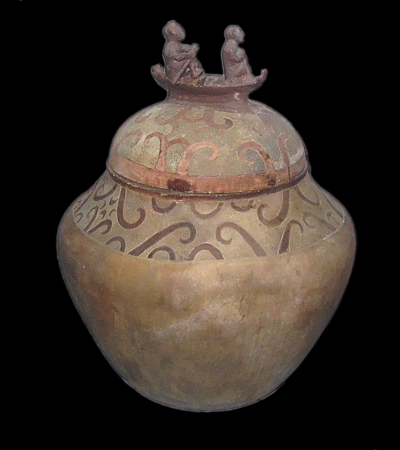 Beautiful old clay jar with two small figures on top.
