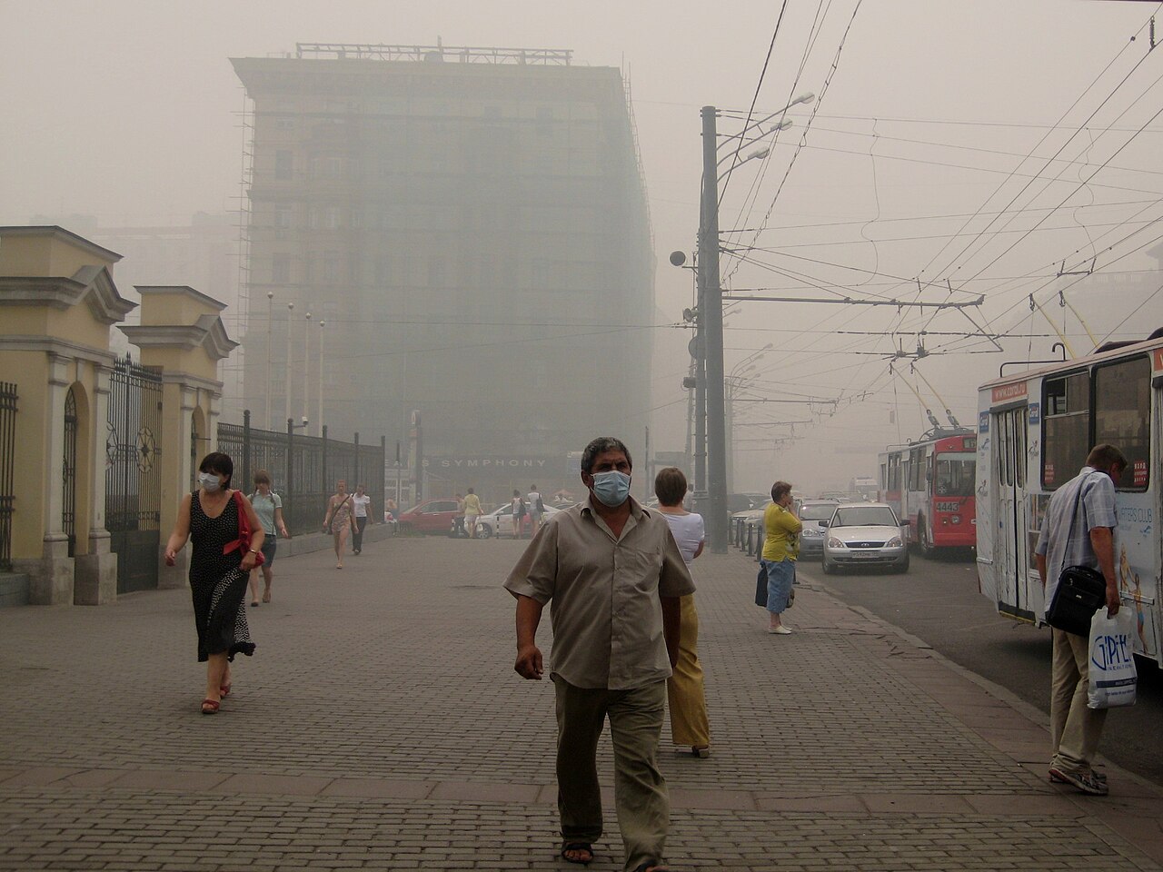 Thick, dirty smog hides the buildings in a busy city.