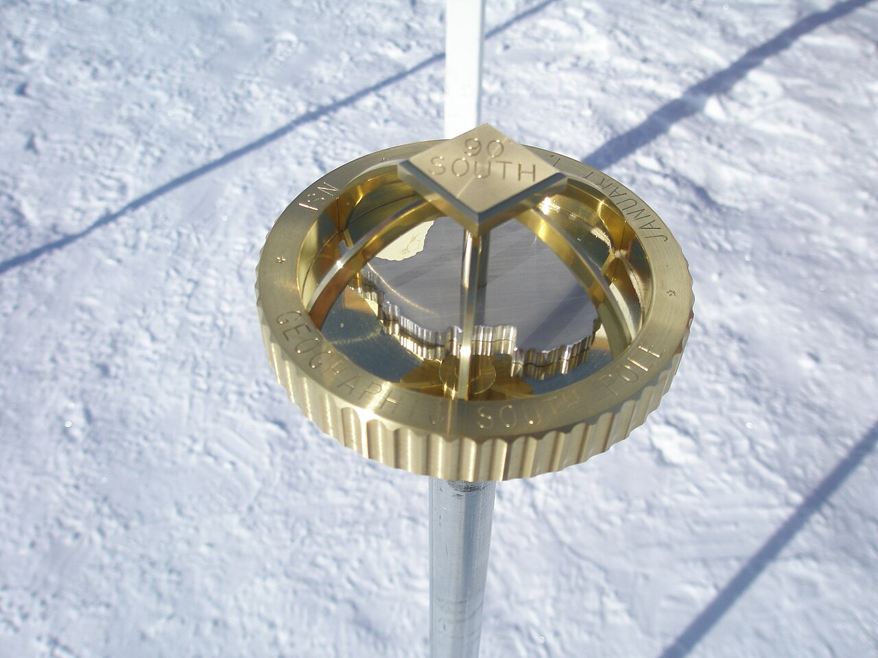 A marker showing the exact spot of the South Pole.
