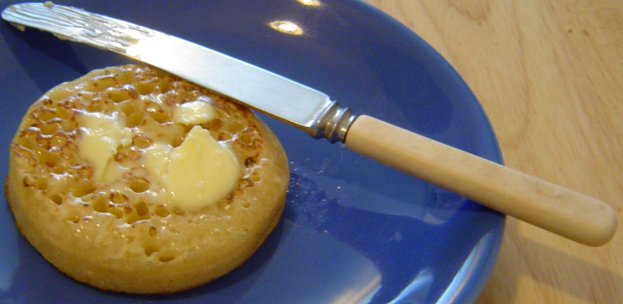 A warm crumpet with melty butter on top.