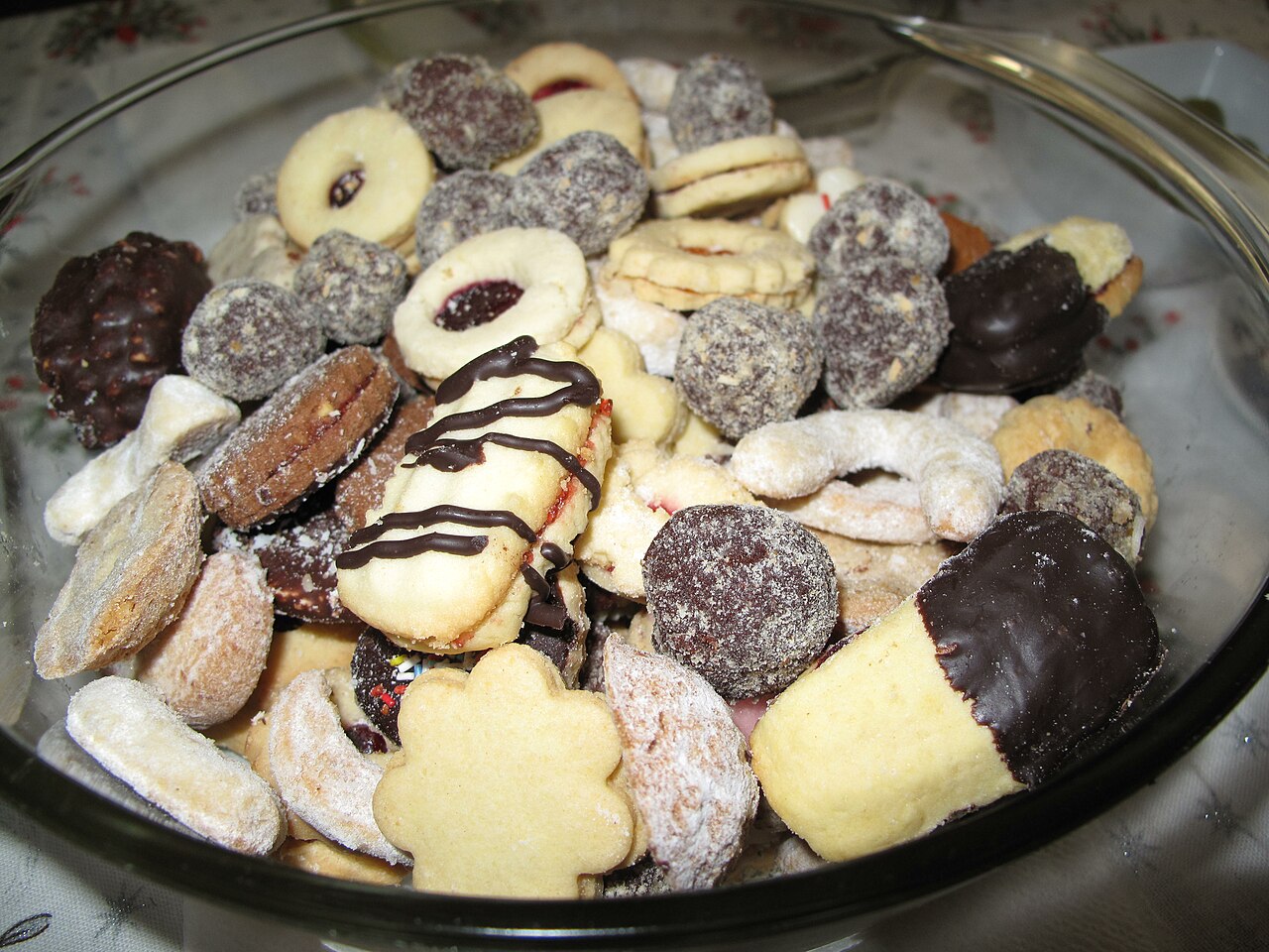 A plate with many different kinds of tasty cookies.