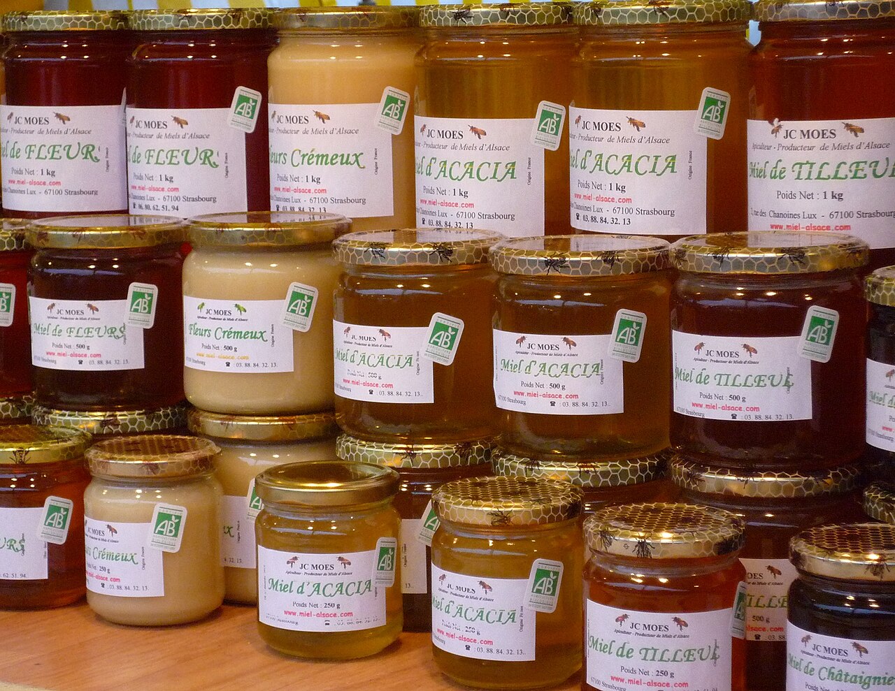 A jar of golden honey made by busy bees.