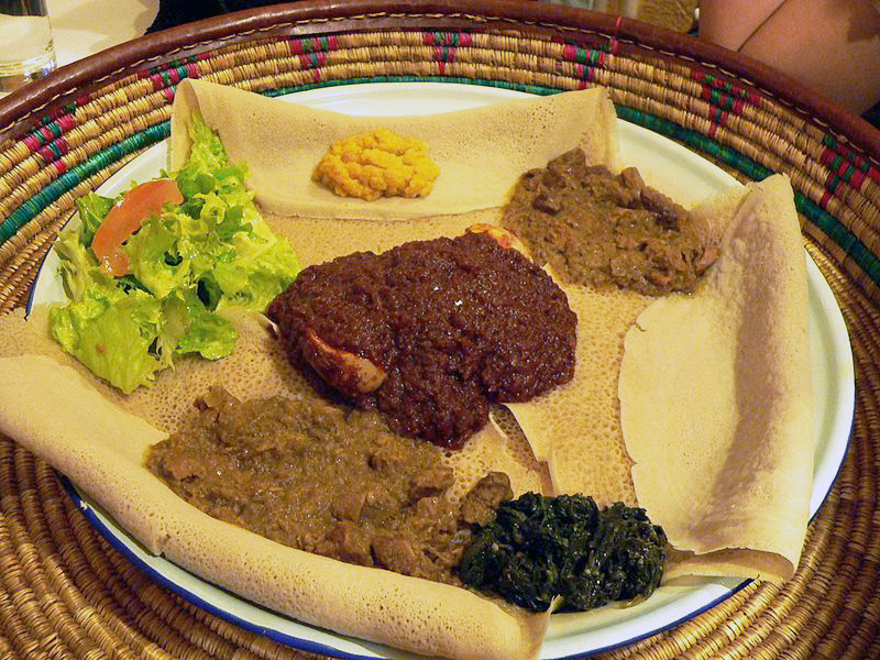 Soft flat pancakes served with chicken and a tasty stew.