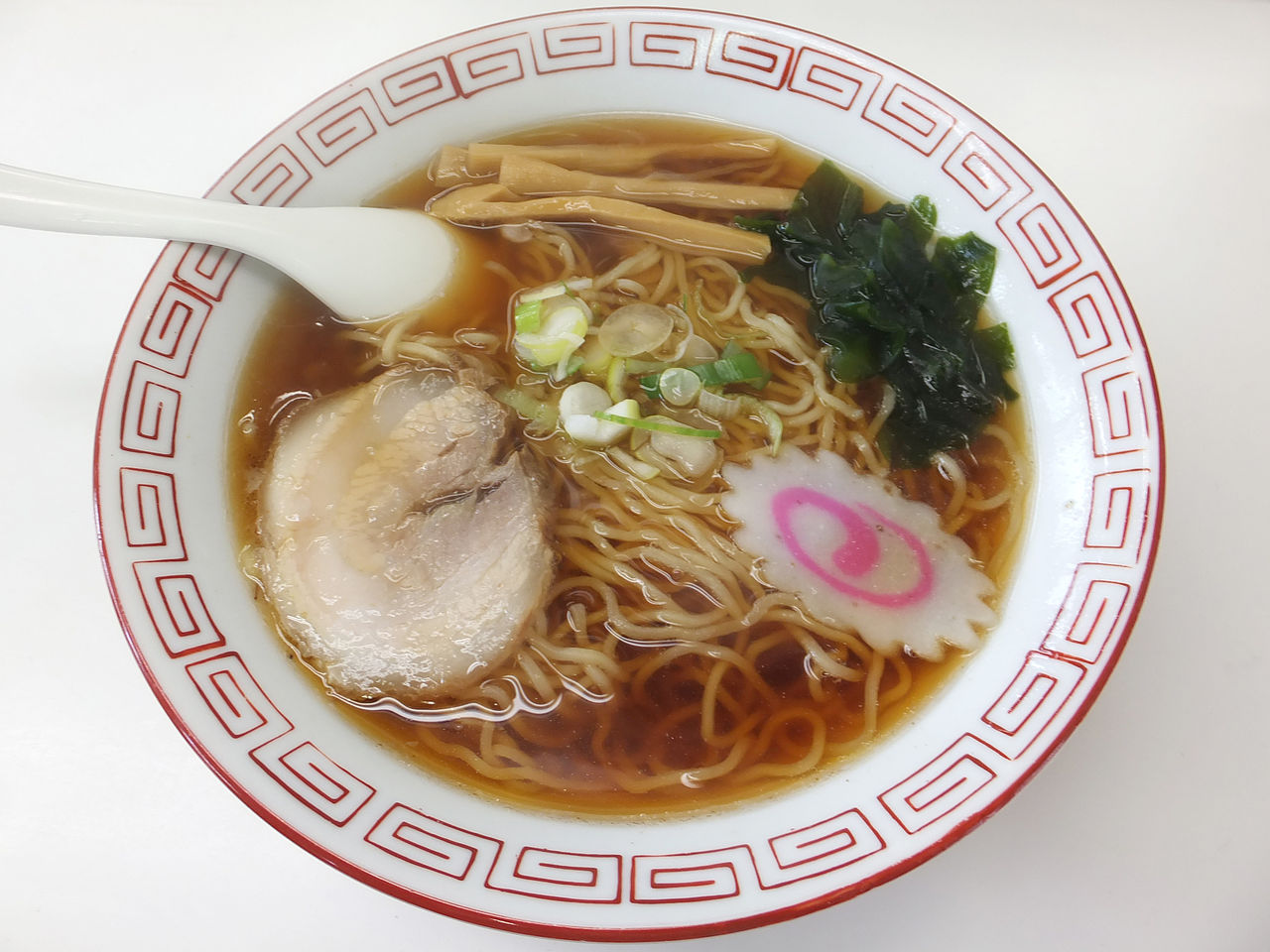 A steamy bowl of soy sauce ramen at a train station shop.