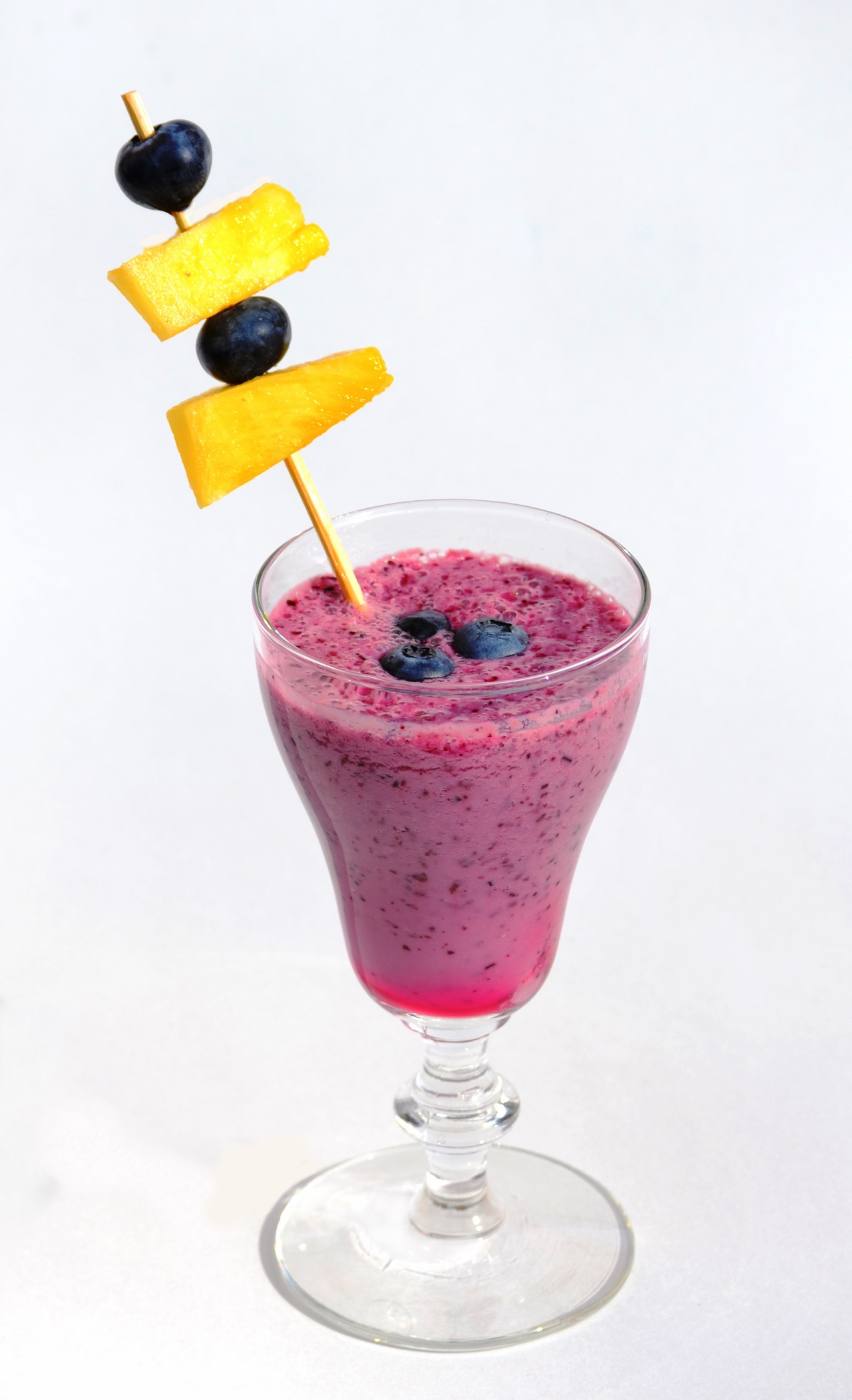 A cool, fruity smoothie in a tall glass.