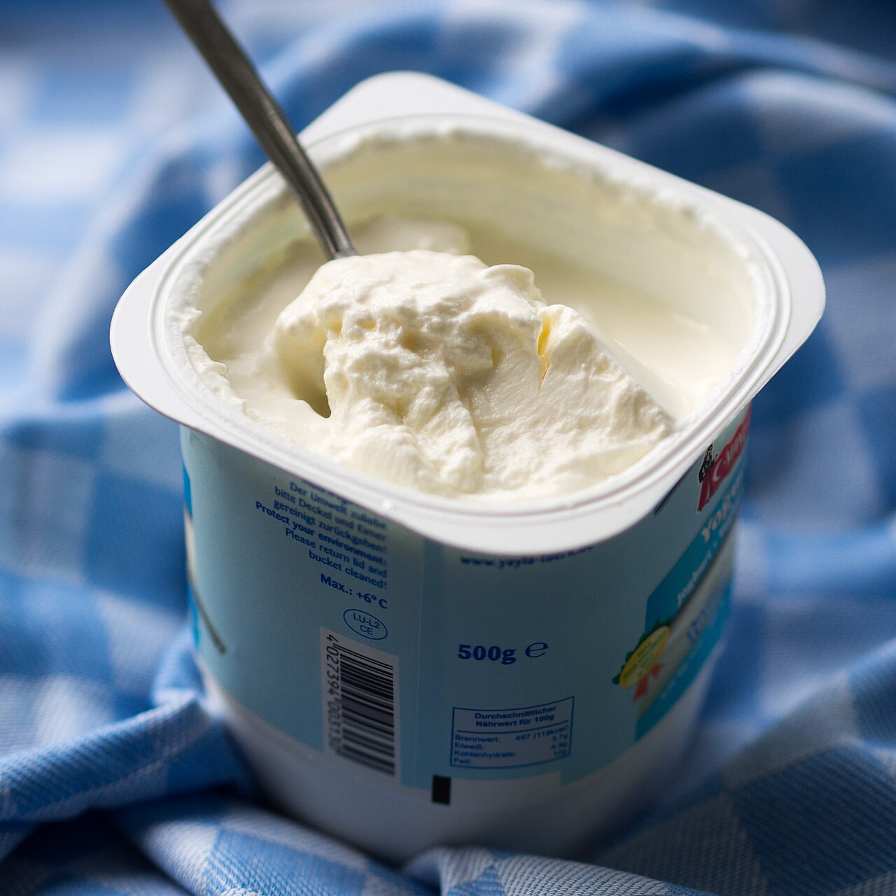 A fresh tub of thick, creamy yogurt.