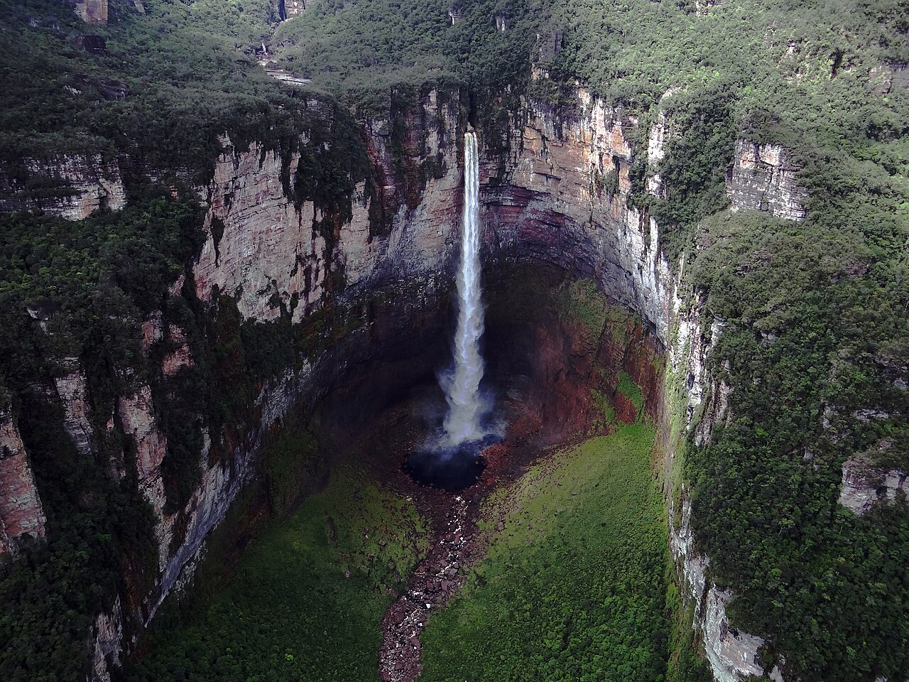A huge flat-topped mountain rises where Angel Falls drops.