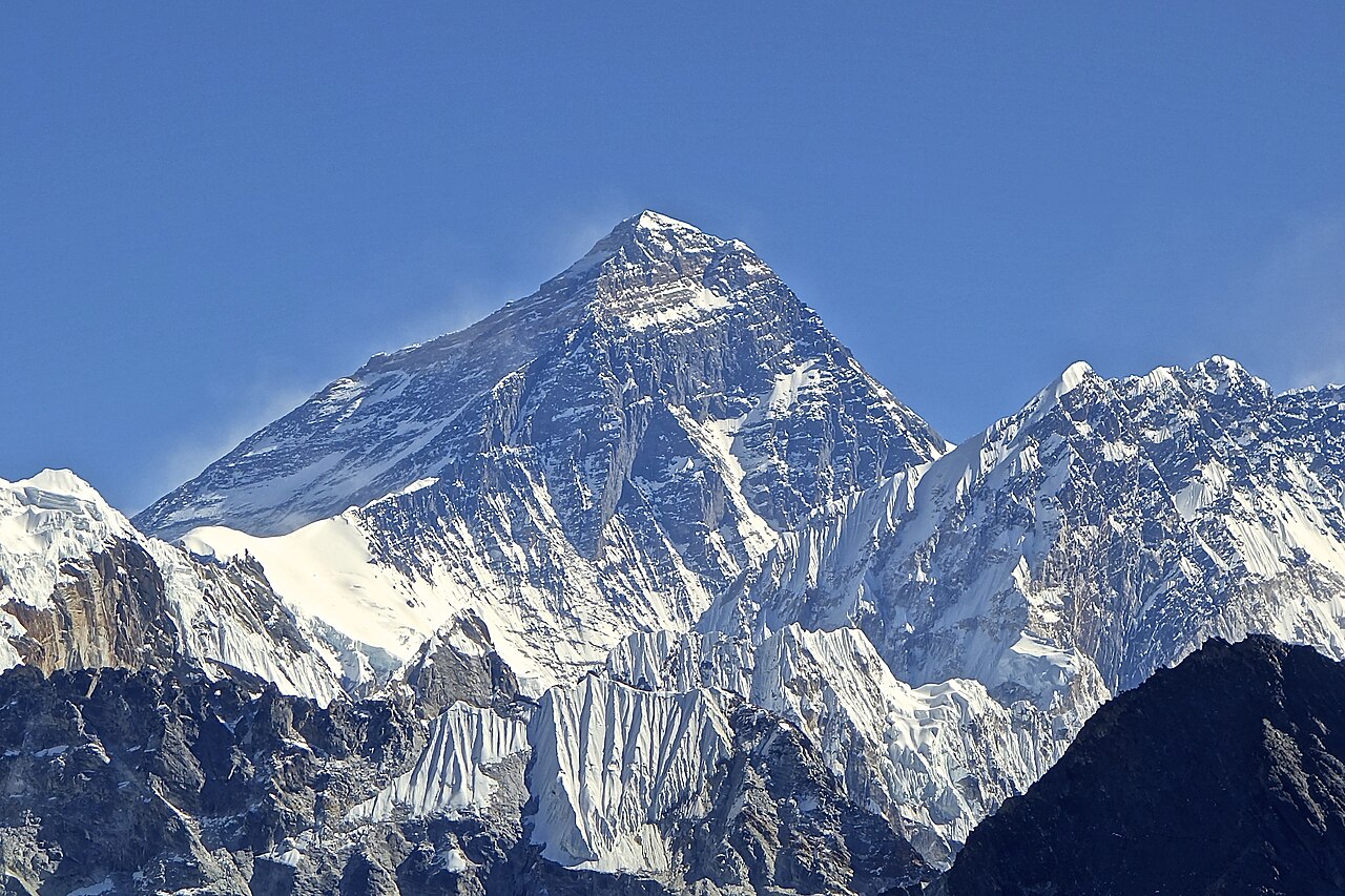Snowy Mount Everest towers high above the clouds.