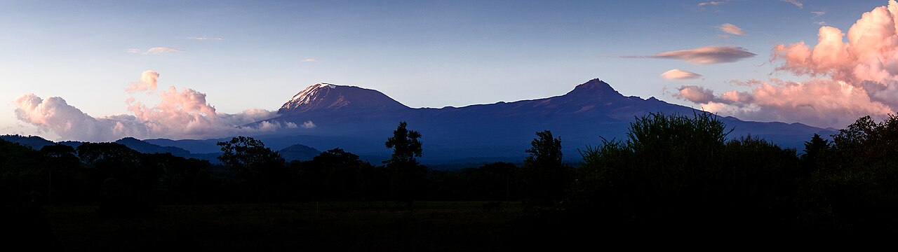 Two snowy peaks of Mount Kilimanjaro rise above the plains.