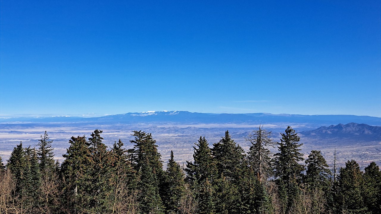 The Rocky Mountains stretch far into the sunny distance.