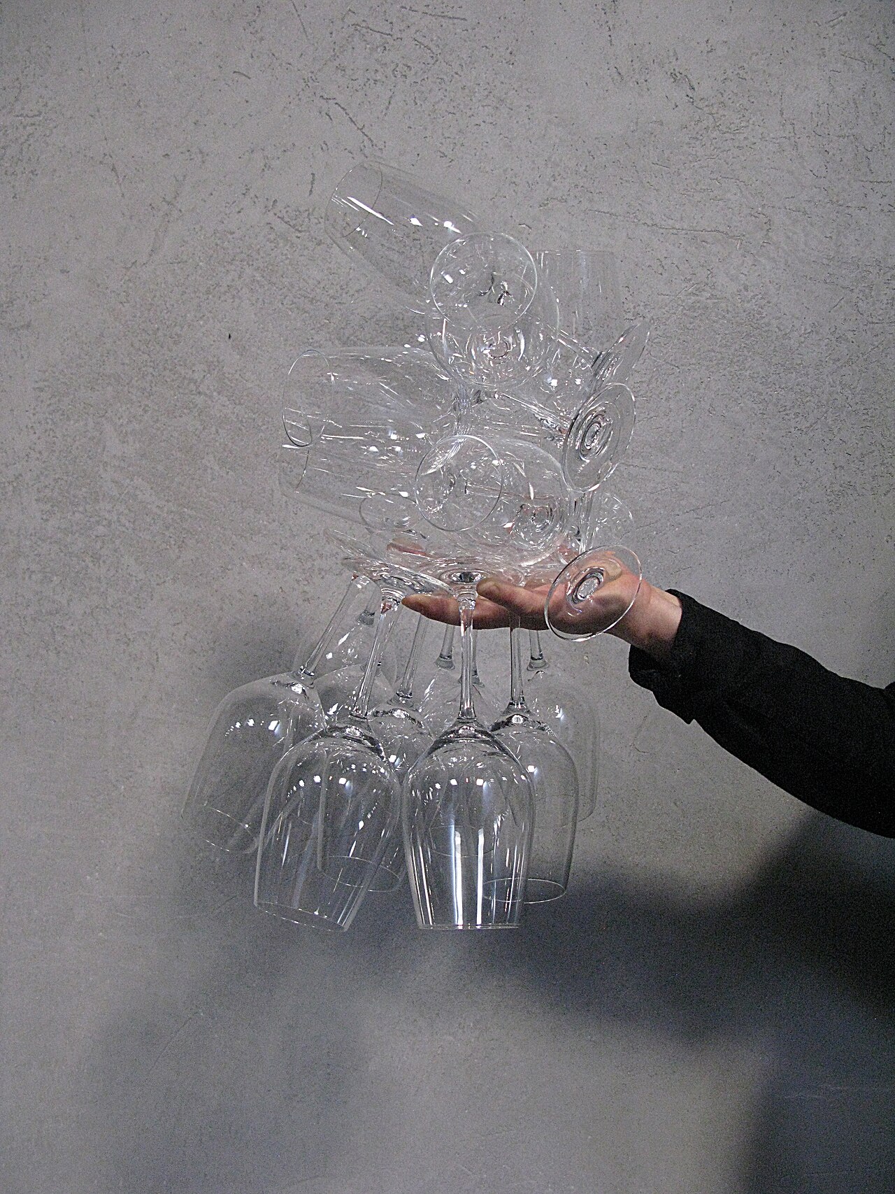 A waiter balances many glasses in just one hand.