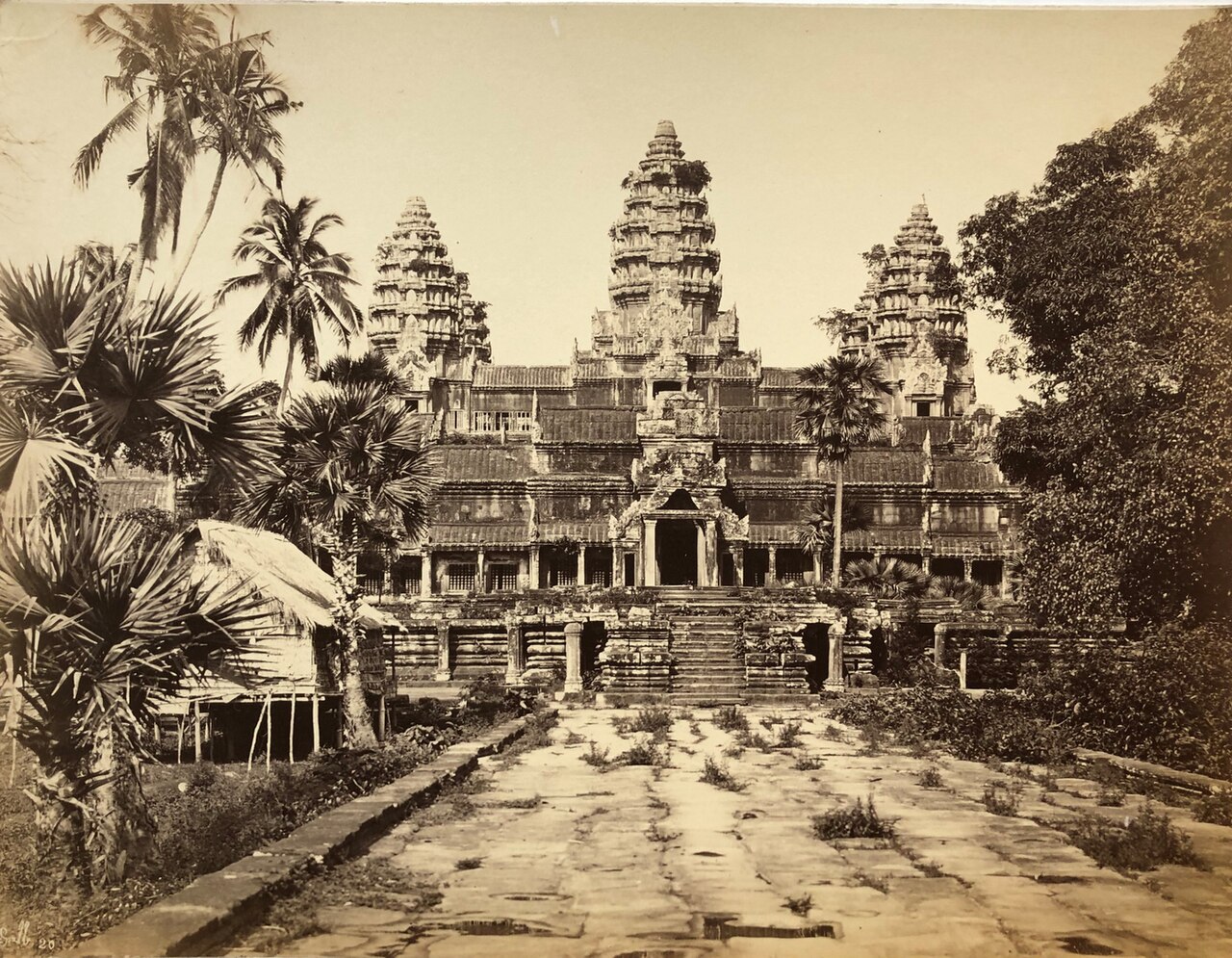 The huge stone temple of Angkor Wat rises above the jungle.