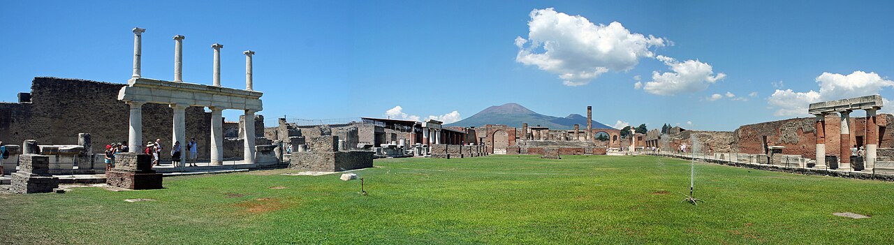 Pompeii's ancient ruins sit below the tall volcano Vesuvius.