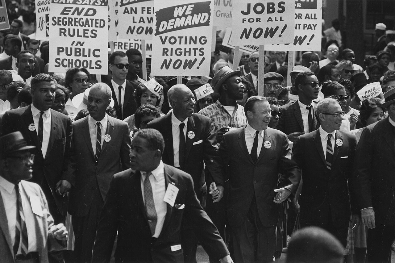 Leaders stand together at a big march for equal rights.