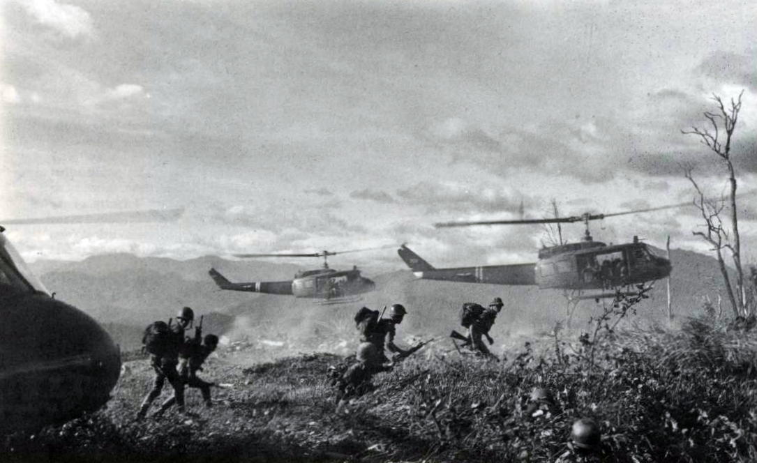 Soldiers ride helicopters into the jungle during the Vietnam War.