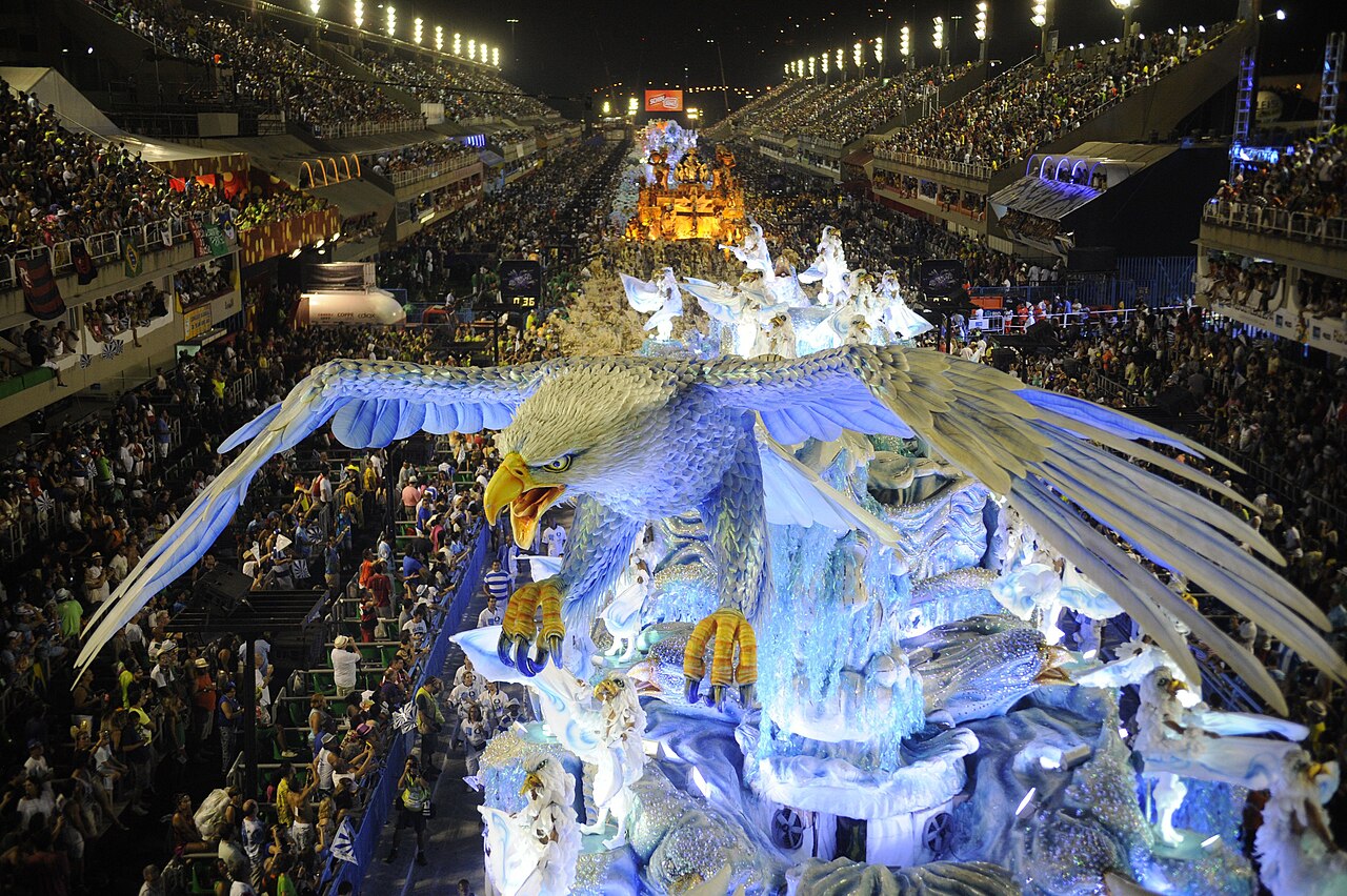 Dancers in sparkly costumes perform at a big Carnival parade.