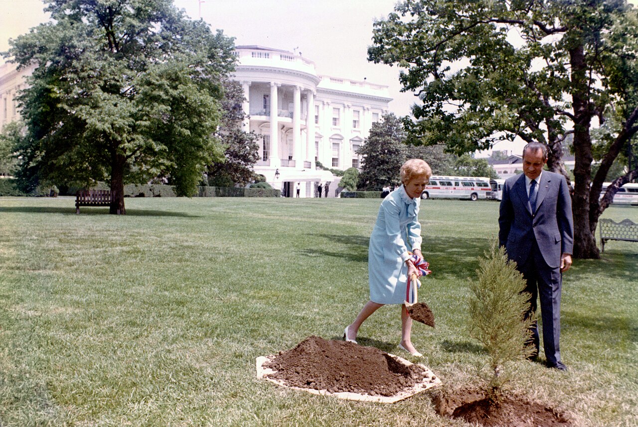 A president and first lady plant a tree for the first Earth Day.