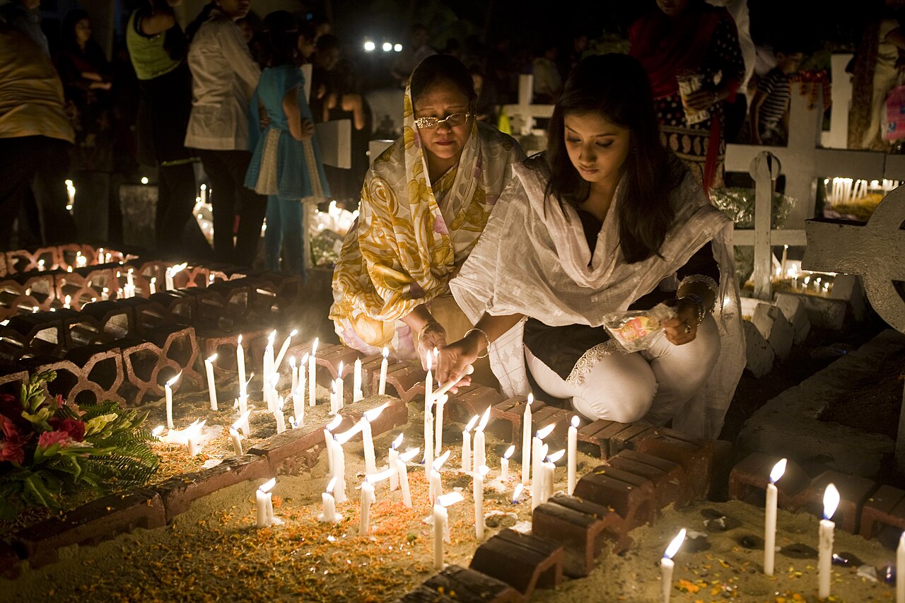 A girl lights a candle to remember loved ones on Halloween.
