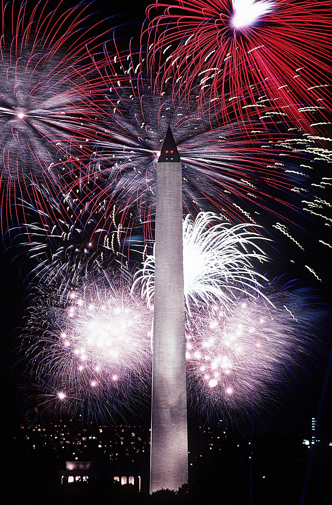 Fourth of July fireworks light up the sky near the Washington Monument.