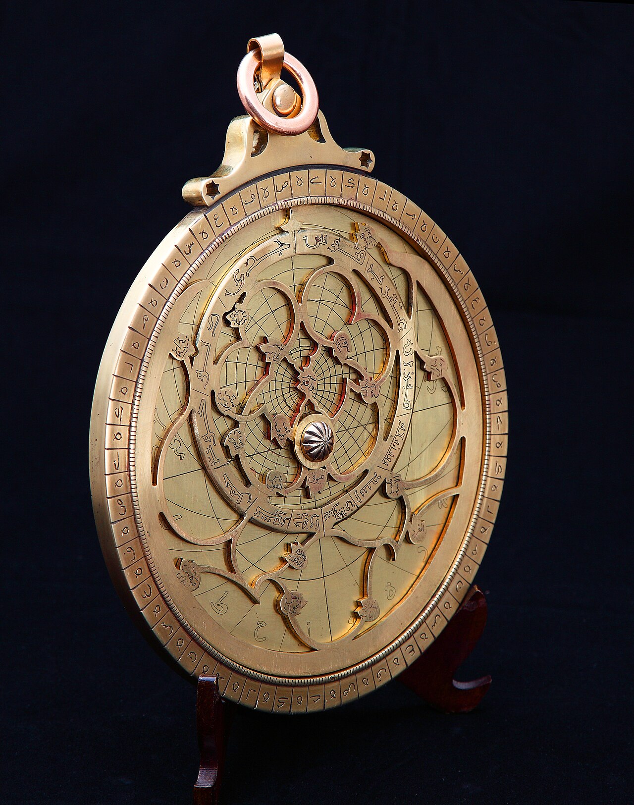 A shiny brass astrolabe used to study the stars.