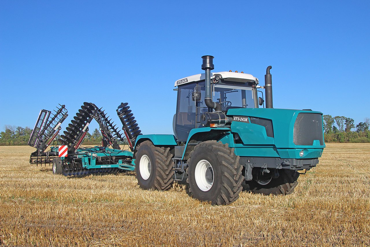 A big, sturdy tractor ready to work on the farm.