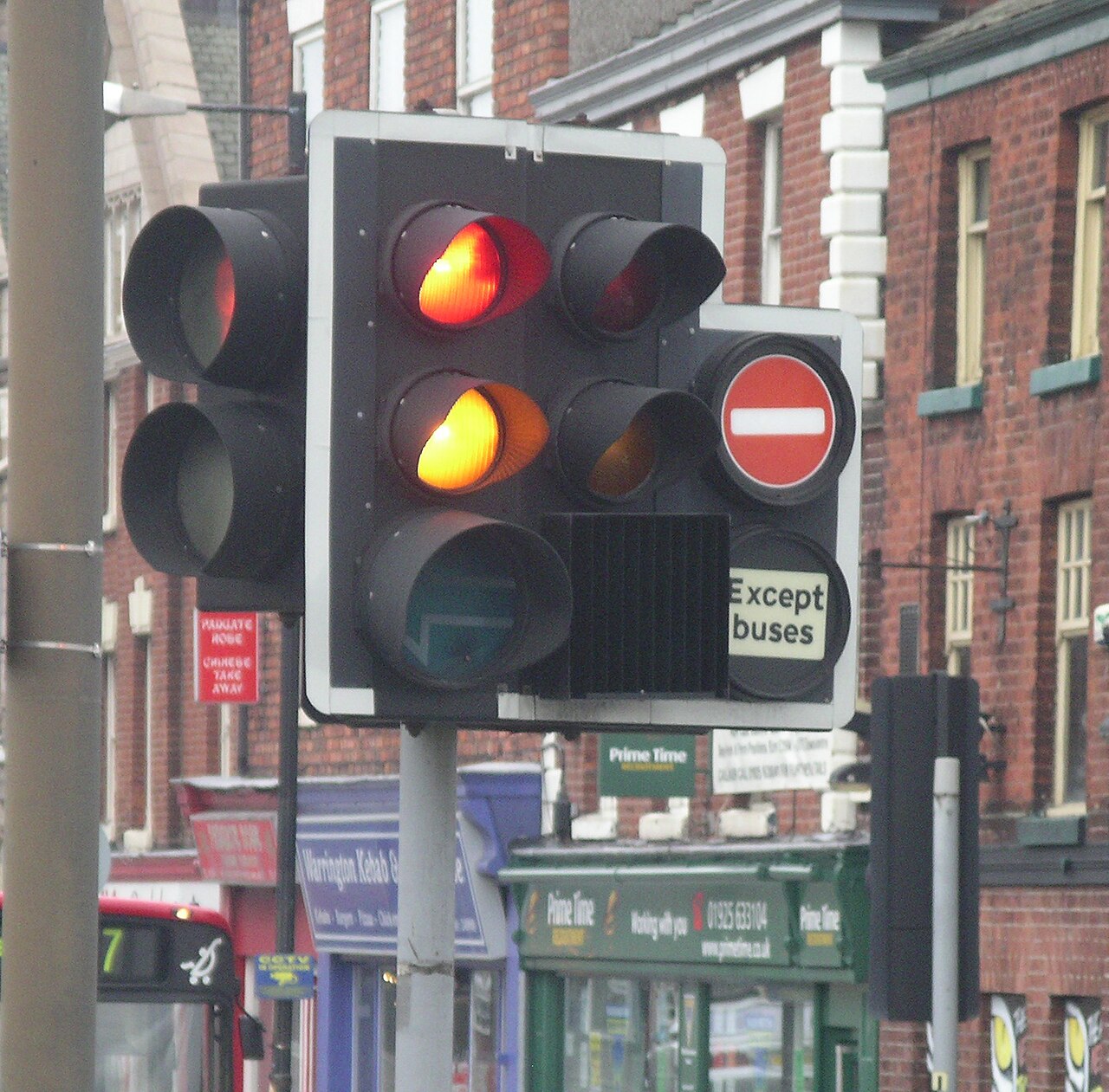 Traffic lights glowing red, yellow, and green.
