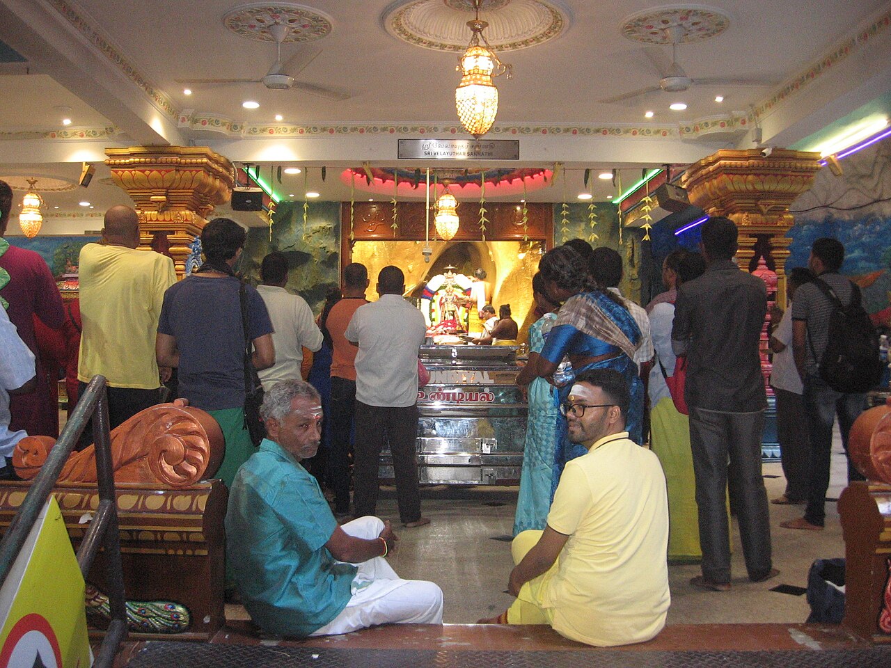 People sharing old folk traditions at a cave temple.