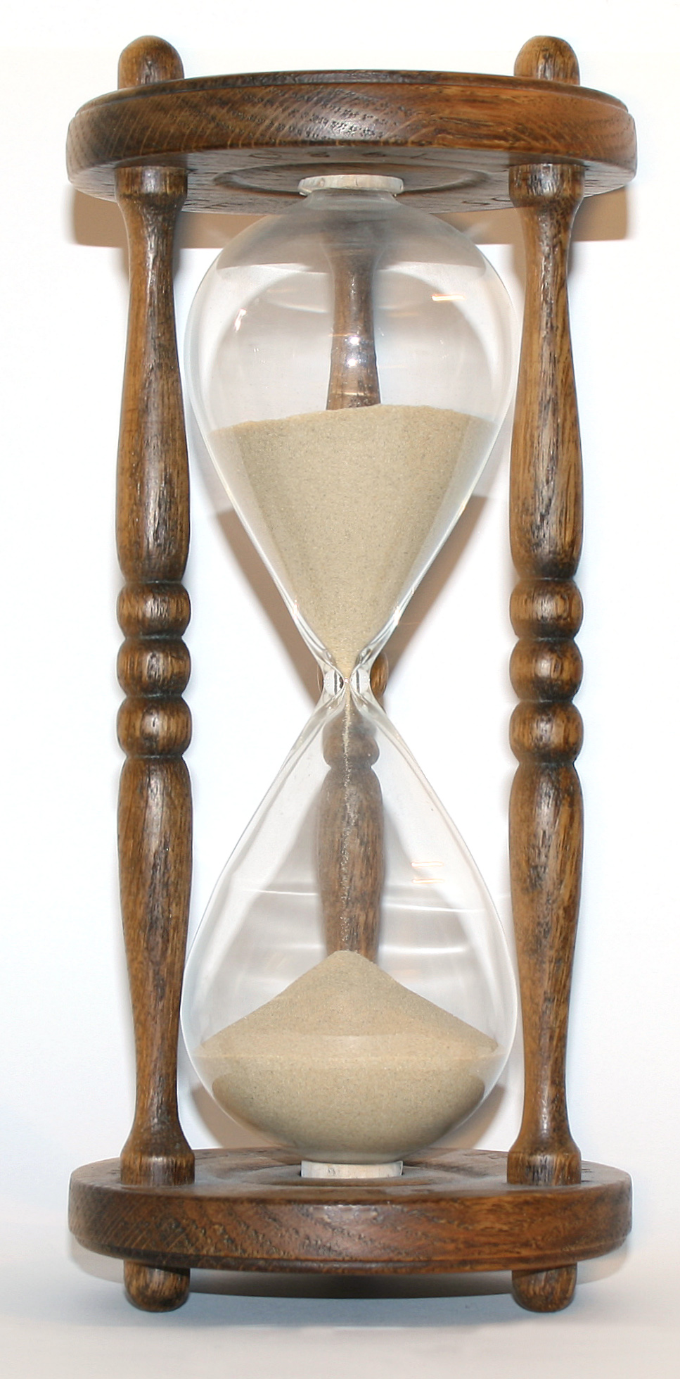 A wooden hourglass uses sand to measure one hour of time.