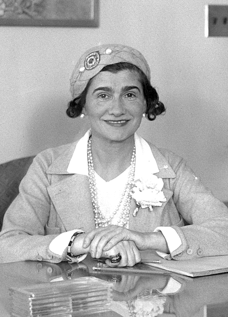 Fashion designer Coco Chanel at her desk in Los Angeles.