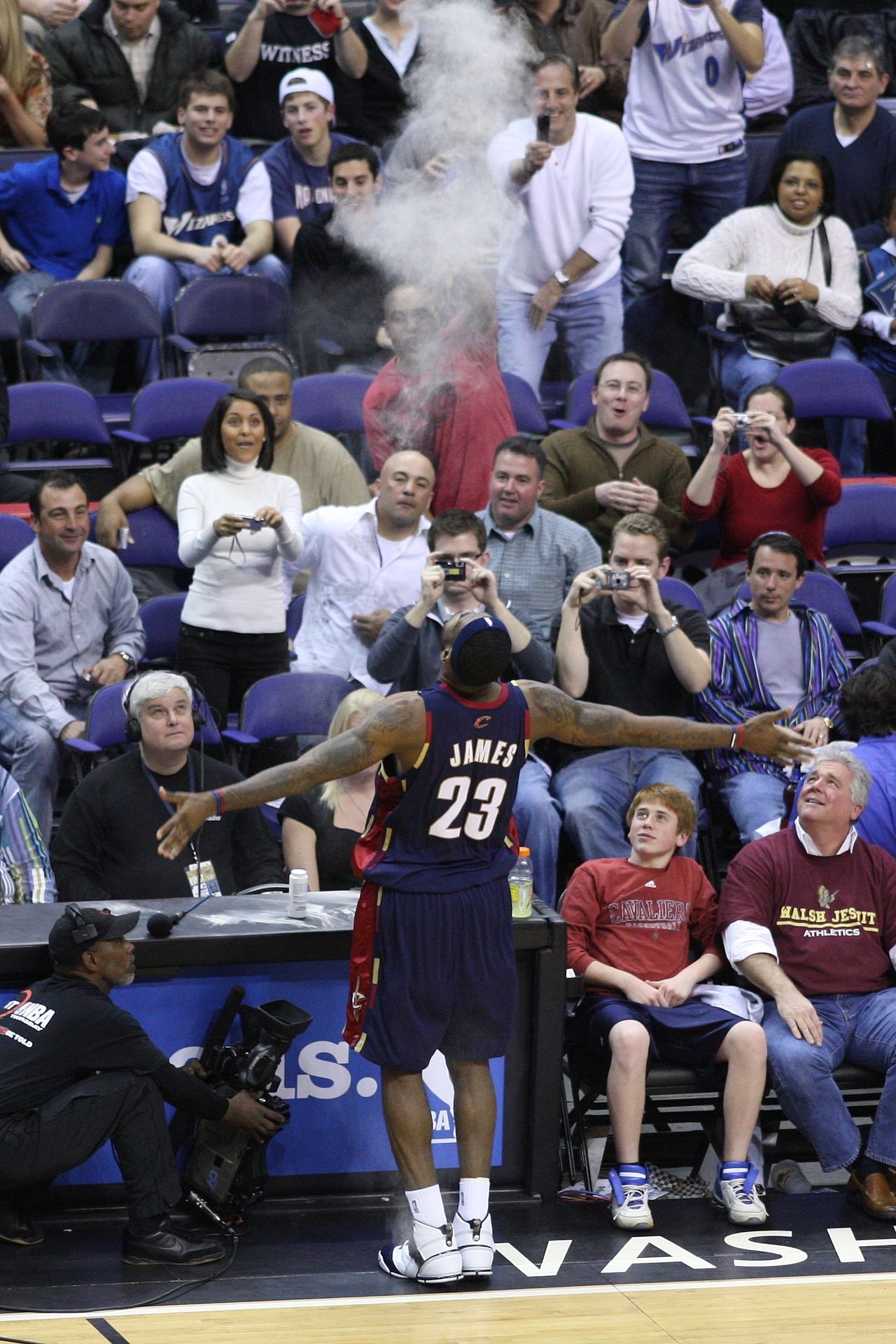 LeBron James tosses chalk powder before a basketball game.