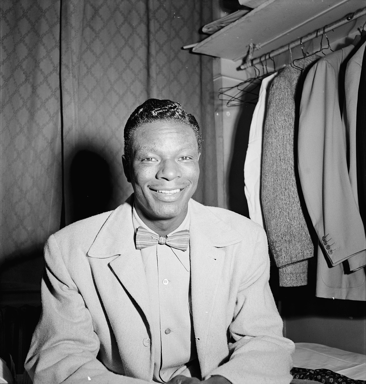 A photograph of singer Nat King Cole at a New York theater.