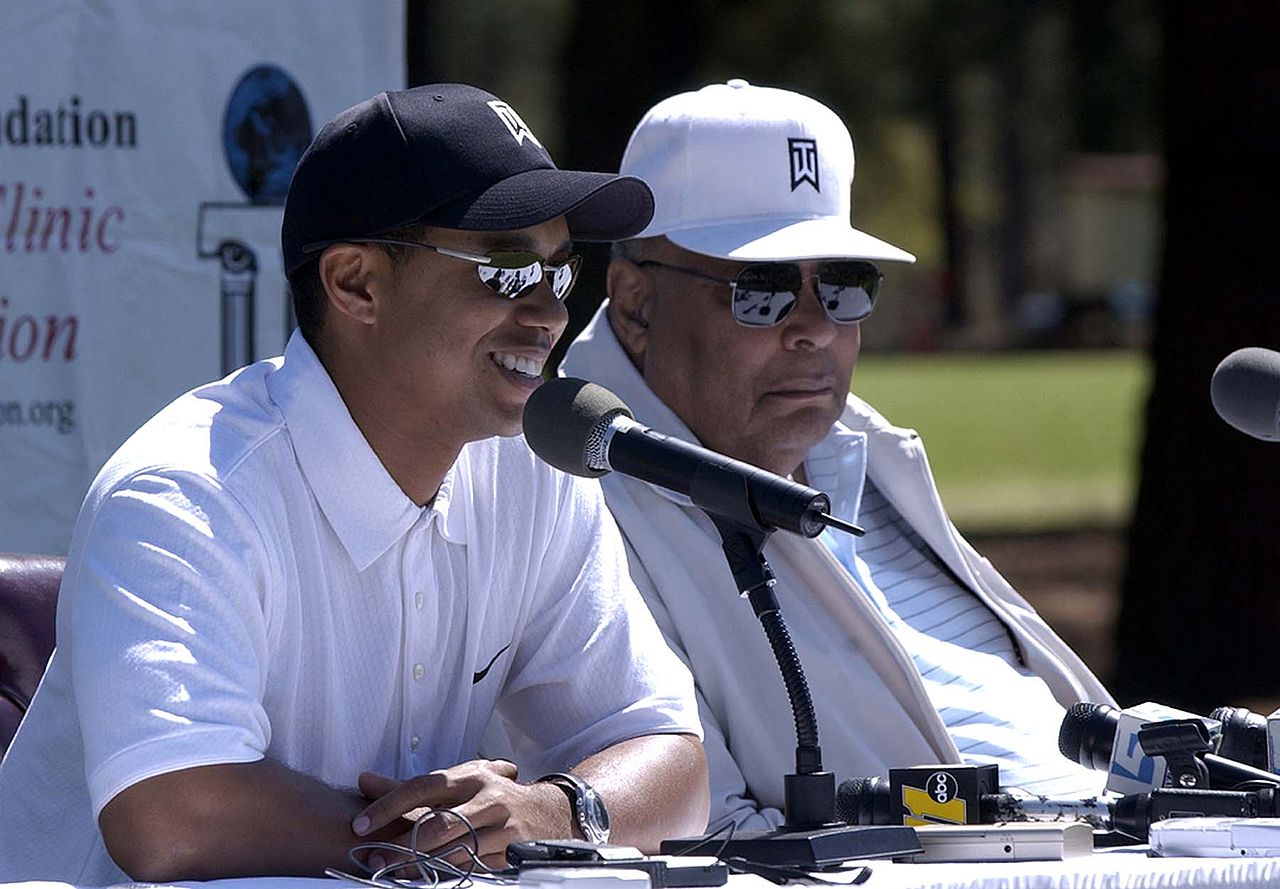 Tiger Woods with his father at a golf clinic for kids.