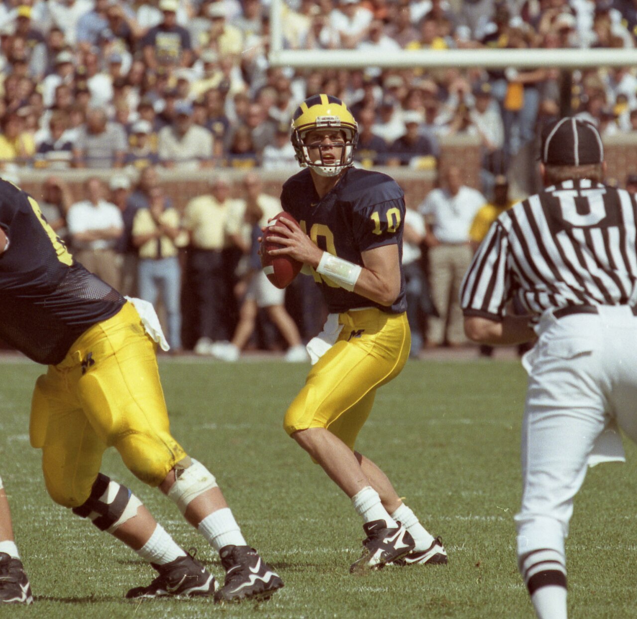 Young Tom Brady playing quarterback for his college team.