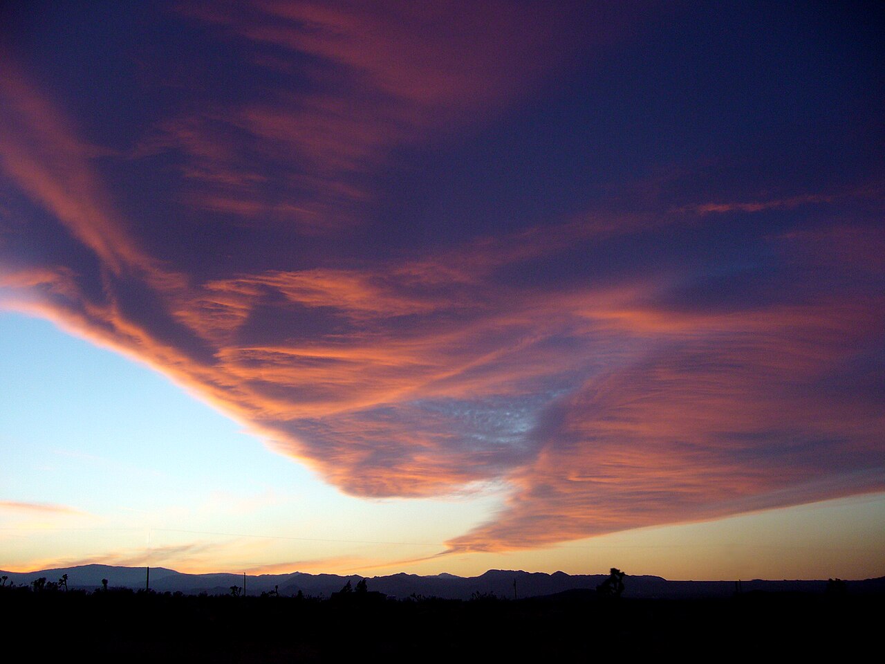 Puffy clouds glow at sunset over the California desert.