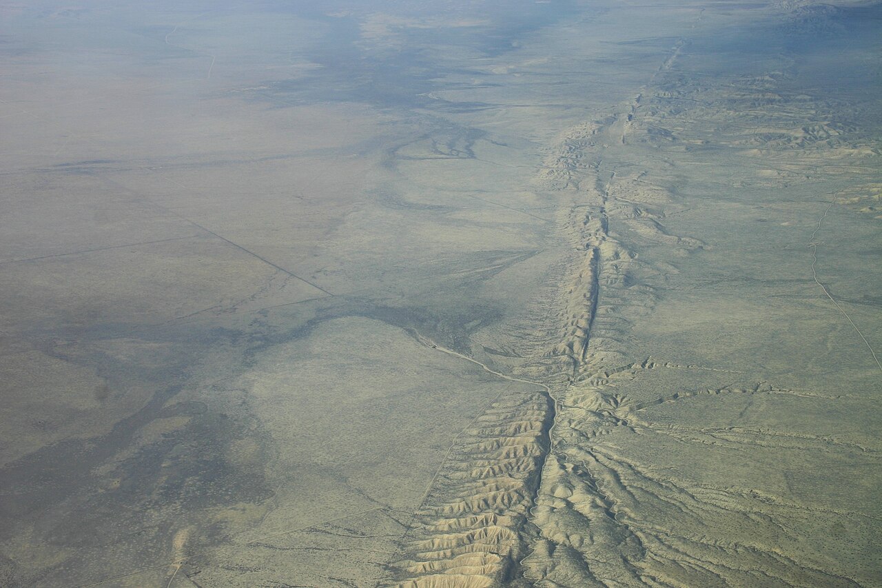 A long crack in the ground shows the San Andreas Fault from above.