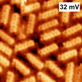 A super close-up image showing tiny molecules on a surface.