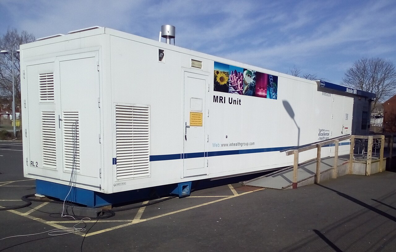 A traveling MRI machine parked outside a health center.