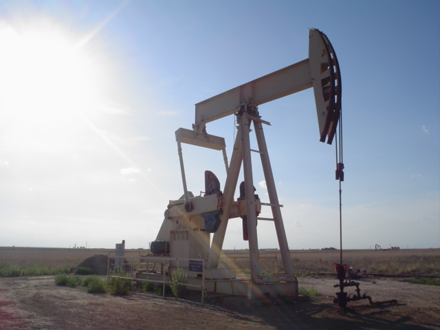 A big oil pumpjack slowly bobs up and down in Texas.