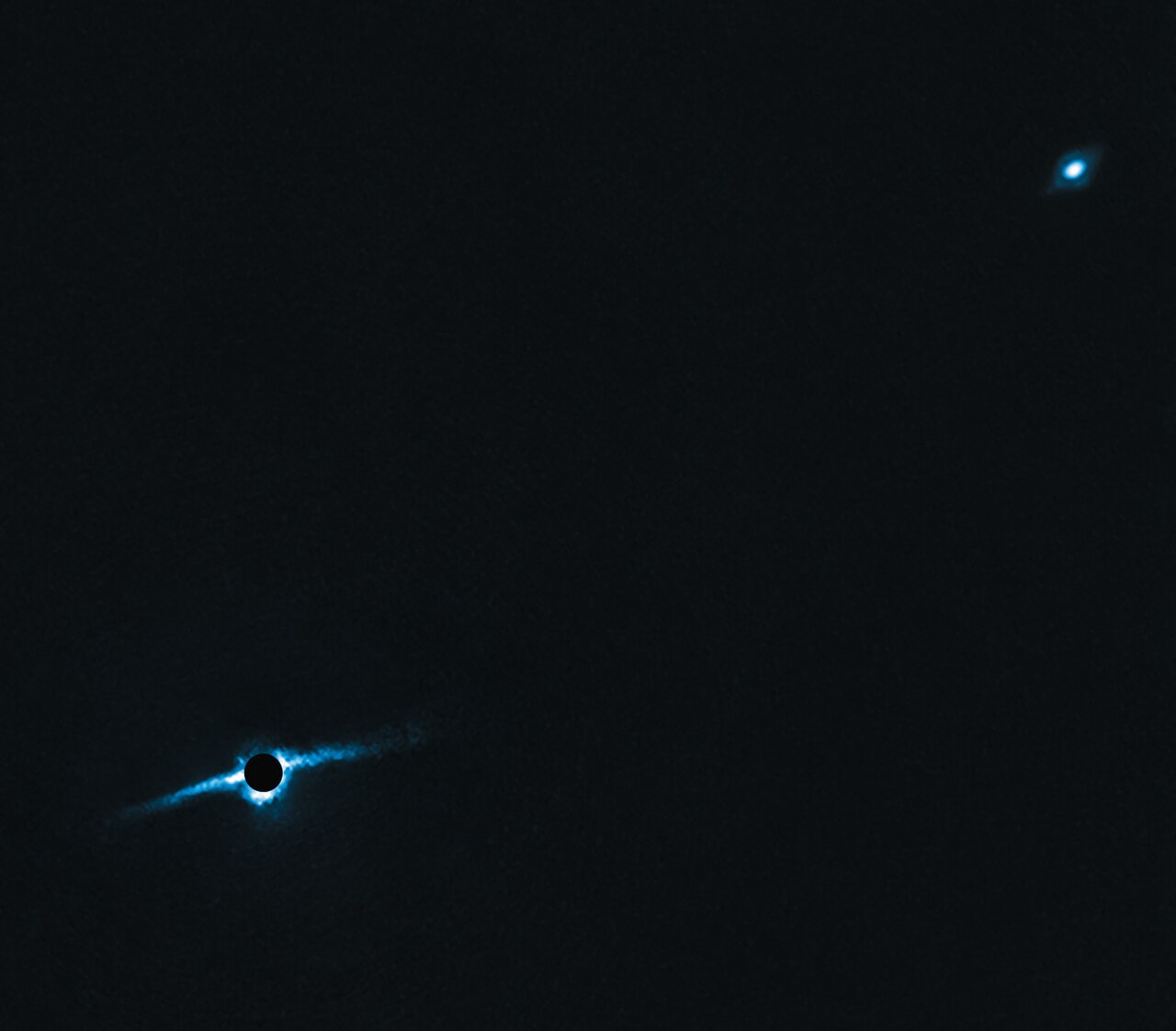 A pair of young stars circled by a bright disk of dust and gas.