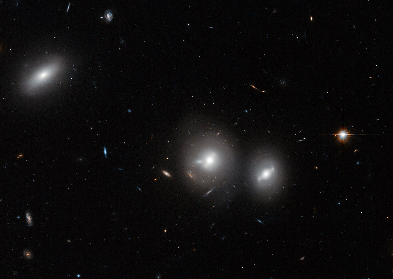 A giant cluster of glowing galaxies held together by invisible dark matter.