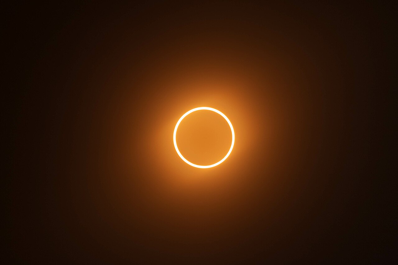 A ring of sunlight glows around the Moon during a solar eclipse.
