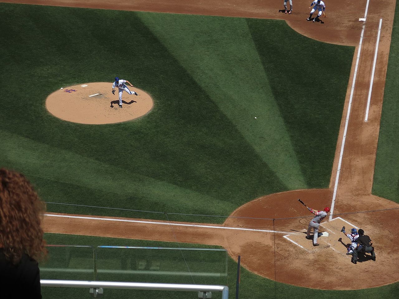 A batter swings hard and sends the ball flying for a home run.