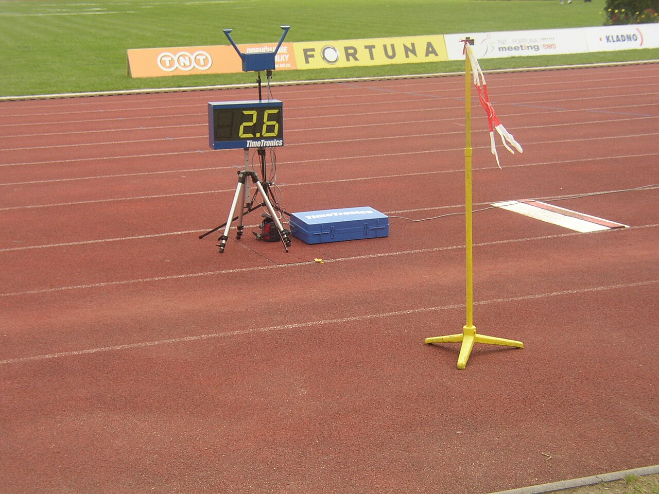 The long jump runway where athletes dash before leaping into the sand.